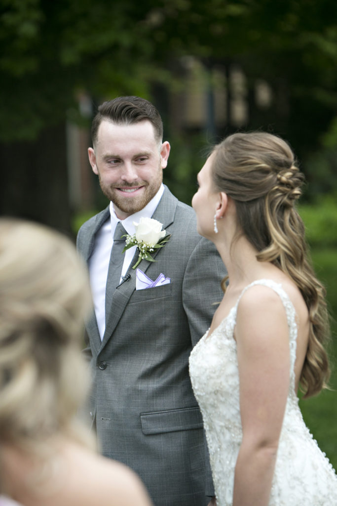 Groom looking at bride during wedding vows